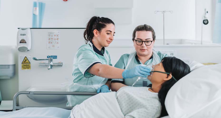 Nursing students providing oxygen mask