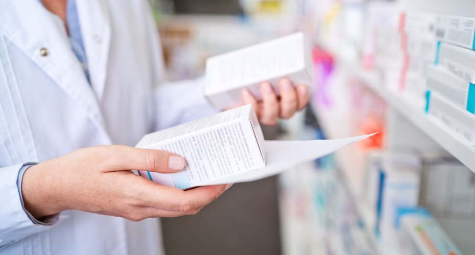 Pharmacist looking at medicine boxes