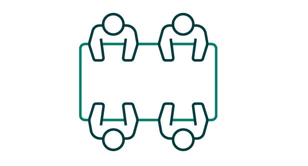 People sat around a meeeting table